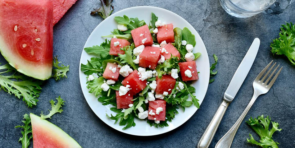 A salad with watermelon and goat cheese.